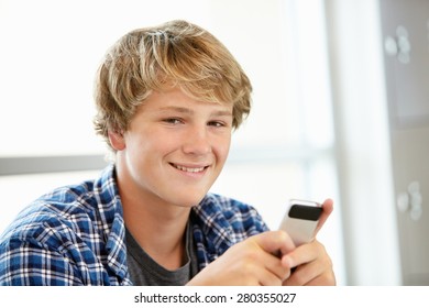 Teenage Boy With Phone In Class