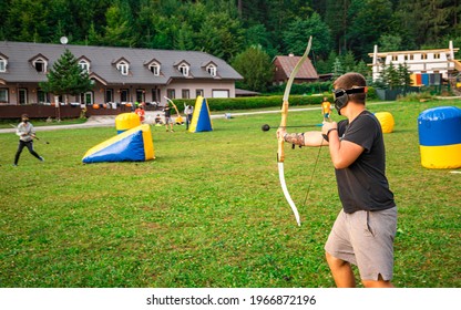 Teenage Boy Playing Archery Tag During Summer