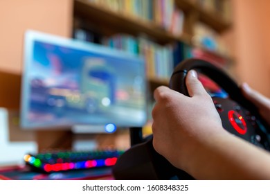 Teenage Boy Playing On Truck Driving Simulator  In Front Of A Computer With Glowing Keyboard, Focus On The Boys Hand, Shallow Depth Of Field, Copy Space.