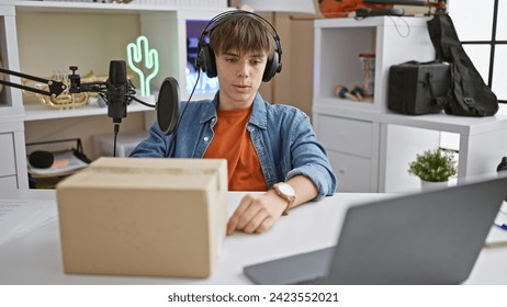 A teenage boy podcasts at a home studio setup with a microphone, headphones, laptop, and a package, depicting modern content creation. - Powered by Shutterstock