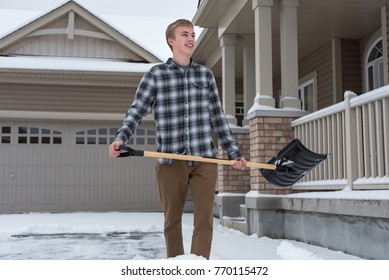 Teenage Boy Shoveling Driveway