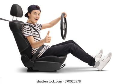 Teenage Boy Sitting In A Car Seat And Giving A Thumb Up Isolated On White Background