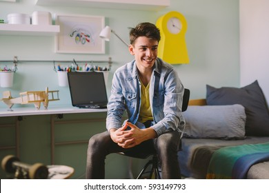 Teenage Boy Sitting  In His Room