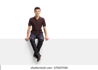 Teenage boy sitting on a panel isolated on white background