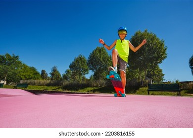 Teenage Boy Skate Stand A Skateboard At Skatepark Pose On Ramp With Color Pink Surface Wearing Helmet