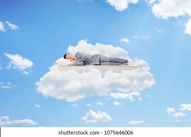 Teenage Boy Sleeping On A Mattress Up In The Sky