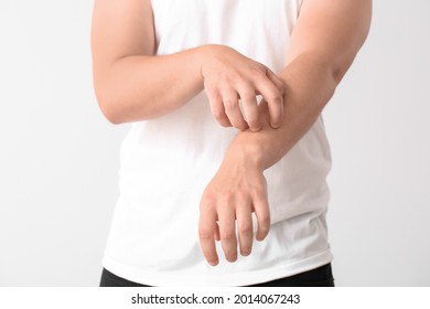 Teenage Boy Suffering From Itching On Light Background