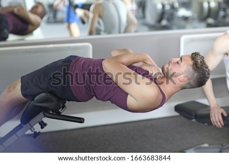 Similar – A teenage boy stretches down, pulling his head to his knees, outdoors