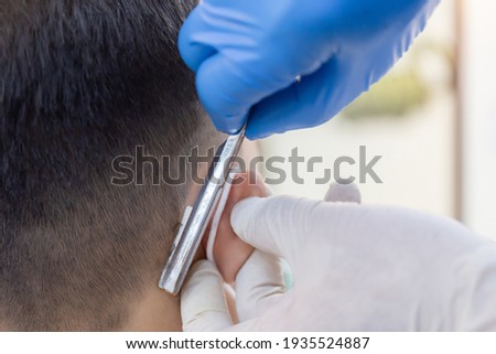 Similar – Beautiful boy getting a haircut with scissors