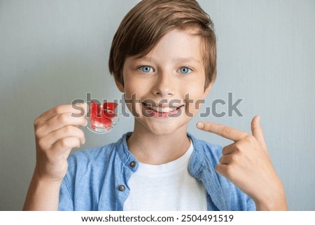 Teenage boy wearing orthodontic braces and showing. Teeth with orthodontic brackets. Dental health care