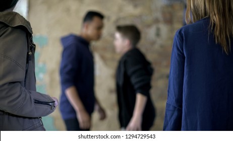 Teenage boys fighting, bullying and self-defense, violence, blurred background