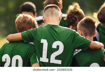 Teenage Boys Freindship In A Sports Team. Group Of Sports Players Huddling In A Circle And Motivating Each Other. Boys In Green Jersey Shirts With Numbers