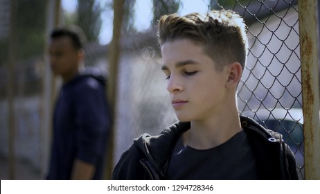Teenage Boys Leaning On Metal Fence, Juvenile Detention Center, Orphanage