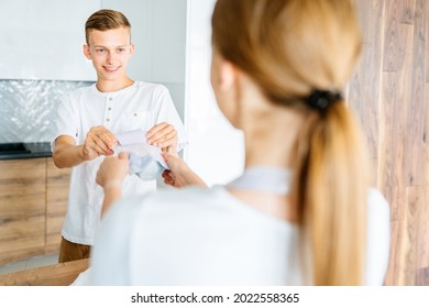 Teenage Brother And Her Adult Sister, Young In 20s, Fighting For Sweet Food At Cozy Home Kitchen Interior.