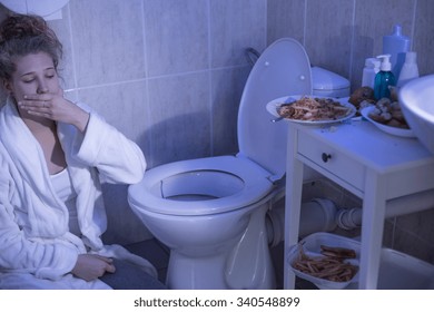 Teenage Bulimic Girl Vomiting In The Bathroom