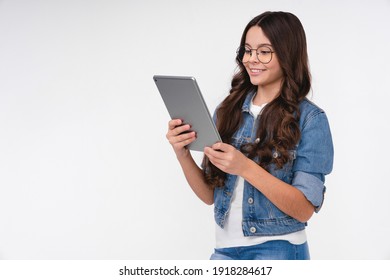 Teenage Caucasian Girl Using Digital Tablet Isolated Over White Background