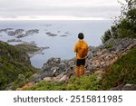 Teenage child, european boy, hikinh mountains in Norway, Senja, summertime