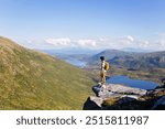 Teenage child, european boy, hikinh mountains in Norway, Senja, summertime