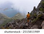 Teenage child, european boy, hikinh mountains in Norway, Senja, summertime