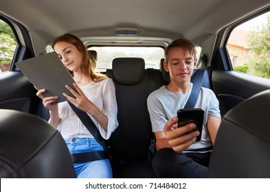 Teenage Children Using Digital Devices On Family Road Trip - Powered by Shutterstock