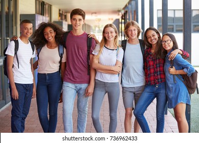 Teenage classmates standing in high school hallway - Shutterstock ID 736962433