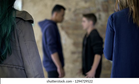 Teenage conflict, two boys fighting for girl, street violence, self-defense