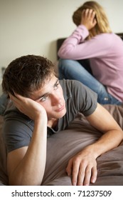 Teenage Couple In Bedroom After Argument