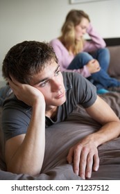 Teenage Couple In Bedroom After Argument