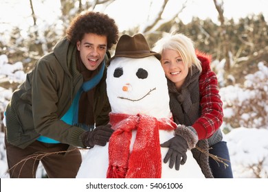 Teenage Couple Building Snowman