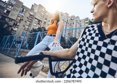 Teenage Couple Hanging Out Outside In Urban Exterior.