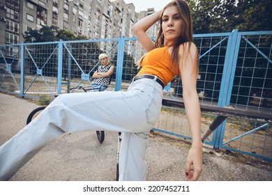 Teenage couple hanging out outside in urban exterior. - Shutterstock ID 2207452711