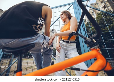 Teenage Couple Hanging Out Outside In Urban Exterior.