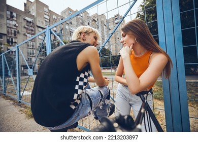 Teenage Couple Hanging Out Outside With A Bicycle.