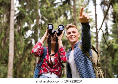 Teenage Couple Hiking In Forest. Summer Vacation.