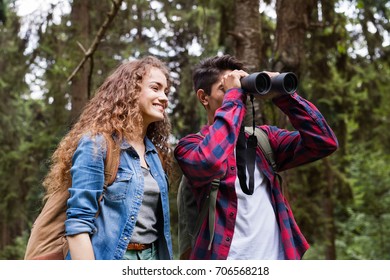 Teenage Couple Hiking In Forest. Summer Vacation.