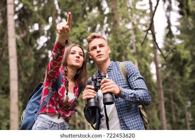 Teenage Couple Hiking In Forest. Summer Vacation.