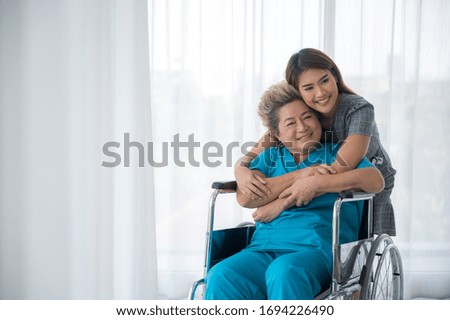 Similar – Doctor talking to elderly patient in a wheelchair