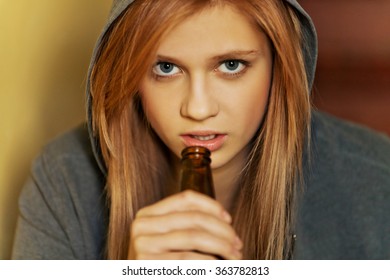 Teenage Depressed Woman Sitting On The Staircase And Drinking A Beer