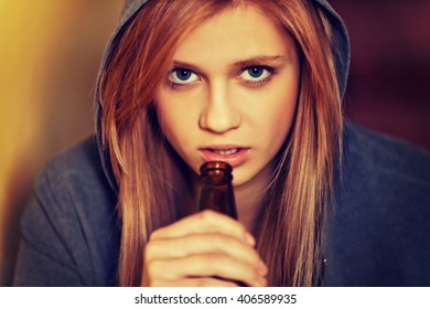 Teenage Depressed Woman Sitting On The Staircase And Drinking A Beer