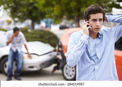 Teenage Driver Making Phone Call After Traffic Accident