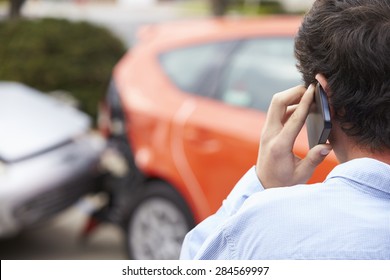 Teenage Driver Making Phone Call After Traffic Accident