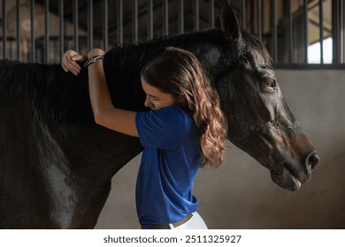 Teenage equestrian girl spends her time after training taking care of the horse she rides, embrace with love and affection equestrian sports, horse riding  - Powered by Shutterstock