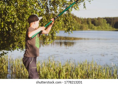 A teenage European boy fishing with a fishing rod in the summer. Fishing on the river in Russia. - Shutterstock ID 1778213201