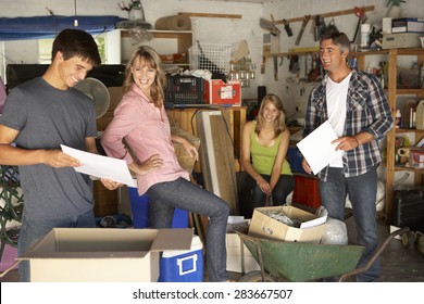 Teenage Family Clearing Garage For Yard Sale