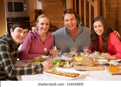 Teenage Family Enjoying Meal In Alpine Chalet Together