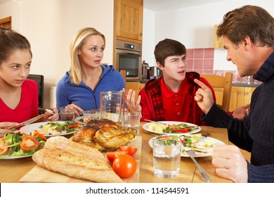 Teenage Family Having Argument Whilst Eating Lunch Together In Kitchen