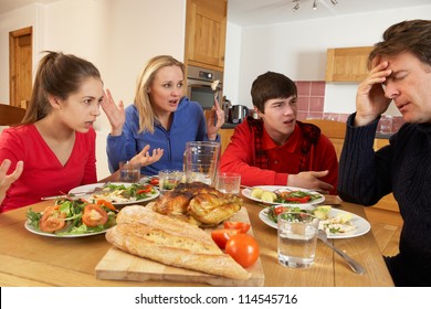 Teenage Family Having Argument Whilst Eating Lunch Together In Kitchen