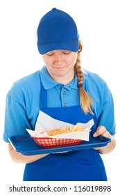 Teenage Fast Food Worker Disgusted By The Burger And Fries She's Serving.  Isolated On White.