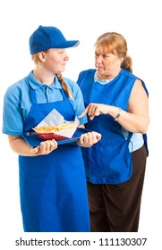 Teenage Fast Food Worker Getting Instructions From Her Middle-aged Boss.  Isolated On White.