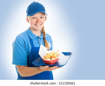 Teenage Fast Food Worker Holding A Tray Of Chicken Nuggets And Fries. Blue Background